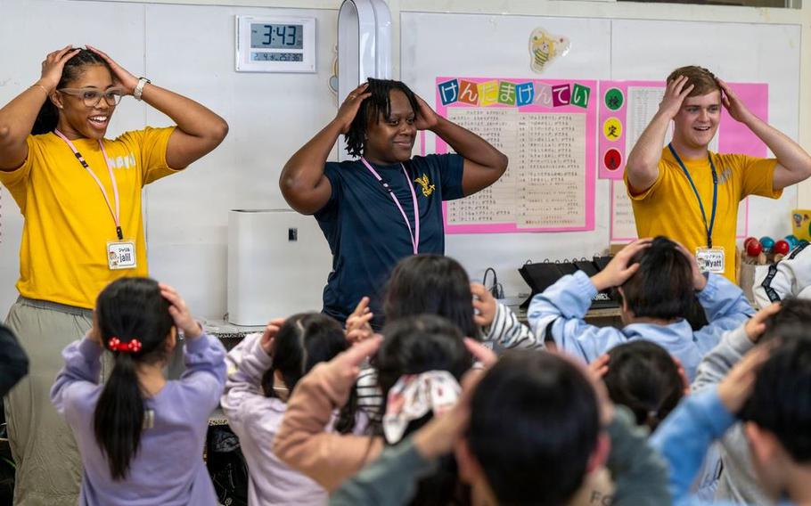 Naval Aircrewman (Mechanical) 2nd Class Wyatt Rivet, a native of Mandeville, LA, Culinary Specialist 2nd Class Mya Howard, a native of Hinesville, GA, and Yeoman Seaman Apprentice Jalil Moorer, a native of Birmingham, AL, lead a song and dance at Hachiken Elementary School during the 76th annual Sapporo Snow Festival.